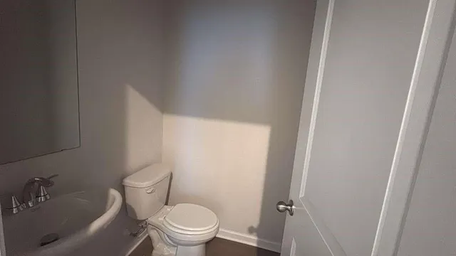 a white toilet sitting next to a bathroom sink