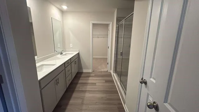 a bathroom with a double vanity sink and a mirror