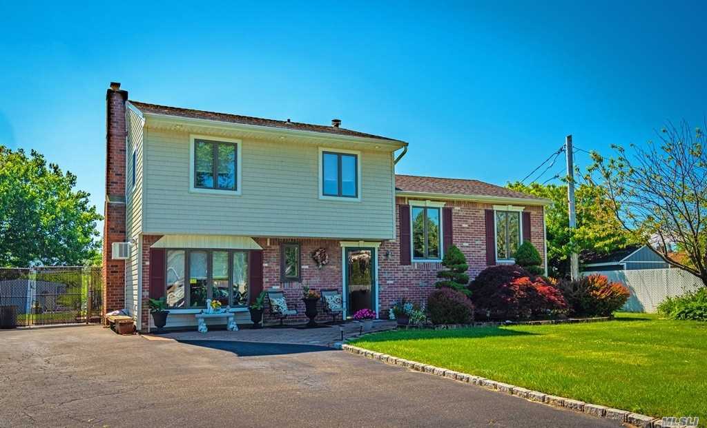199 Blue Point Road West Holtsville, NY 11742 - Photo 1 of 1 a front view of a house with a garden and yard