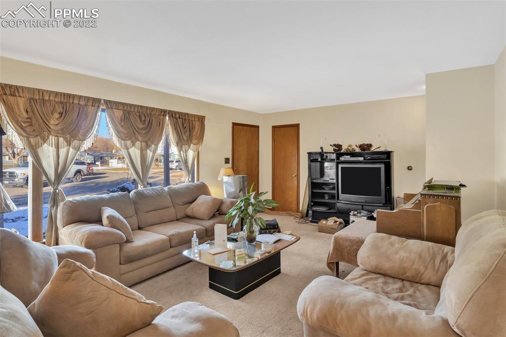 104 Dewey Road Canon City, CO 81212 - Photo 4 of 12 a living room with furniture fireplace and a flat screen tv