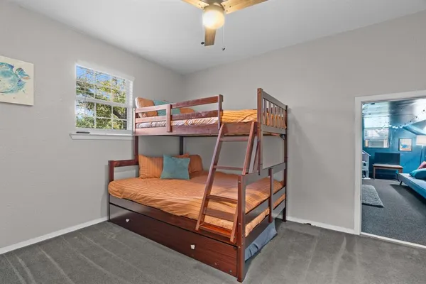 a bedroom with a bed and window