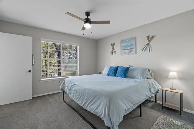 a large bed sitting in a bedroom next to a window