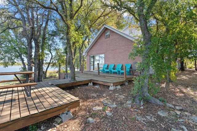 a backyard of a house with table and chairs