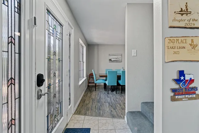 a view of a hallway with paintings on the wall