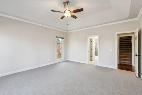 a view of an empty room with a ceiling fan