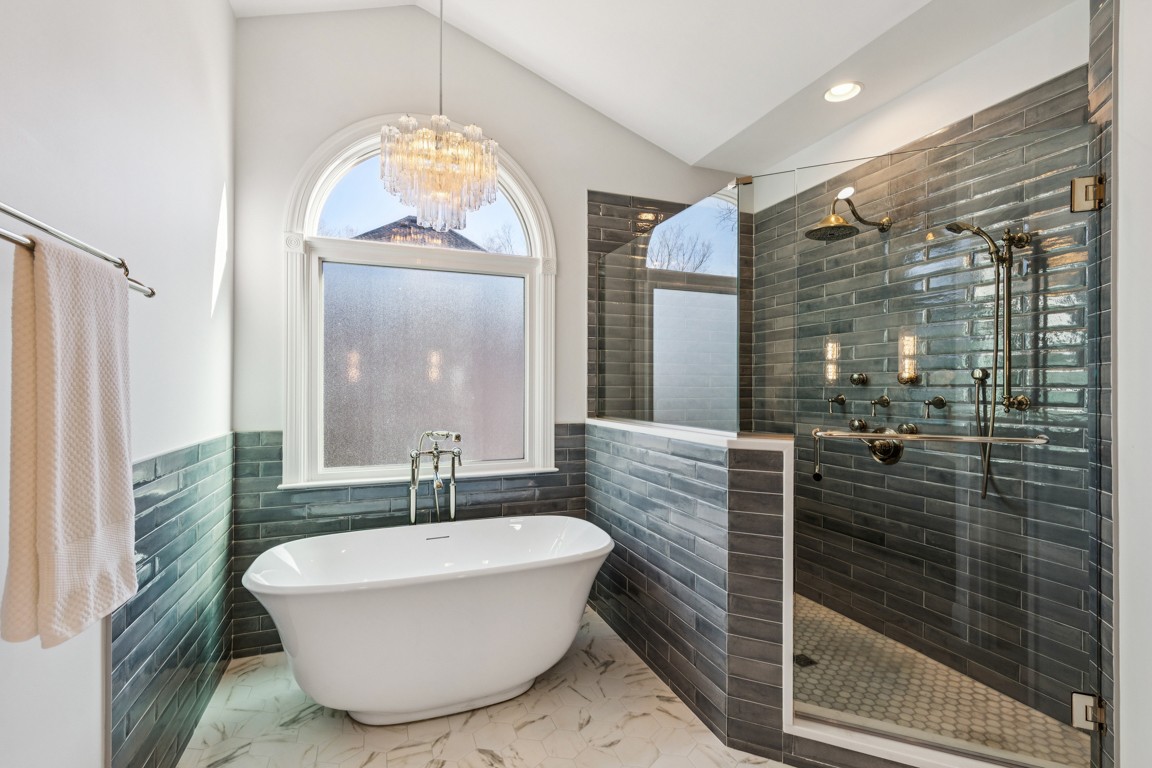 230 Temple Crest Trail Franklin, TN 37069 - Photo 16 of 40 a bathroom with a tub a sink and mirror