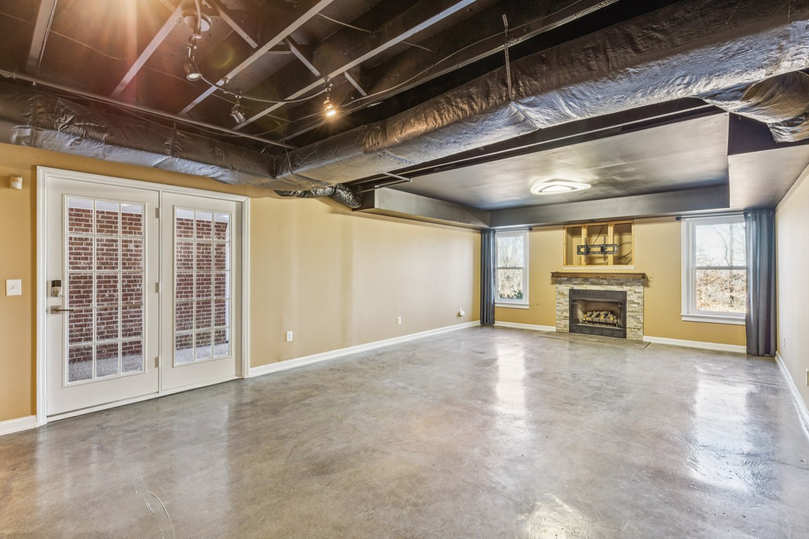 230 Temple Crest Trail Franklin, TN 37069 - Photo 30 of 40 a view of an empty room with a fireplace and a ceiling fan