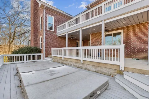 a view of a house with wooden deck