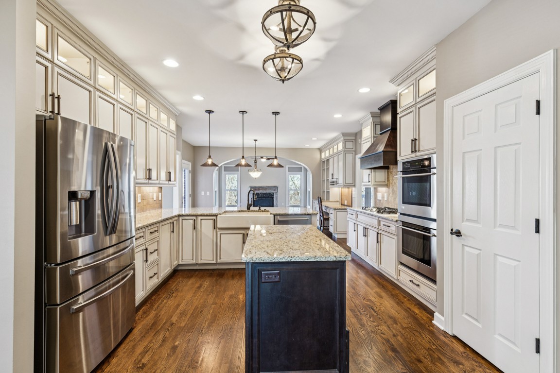 230 Temple Crest Trail Franklin, TN 37069 - Photo 5 of 40 a kitchen with stainless steel appliances granite countertop a refrigerator a stove oven and white cabinets