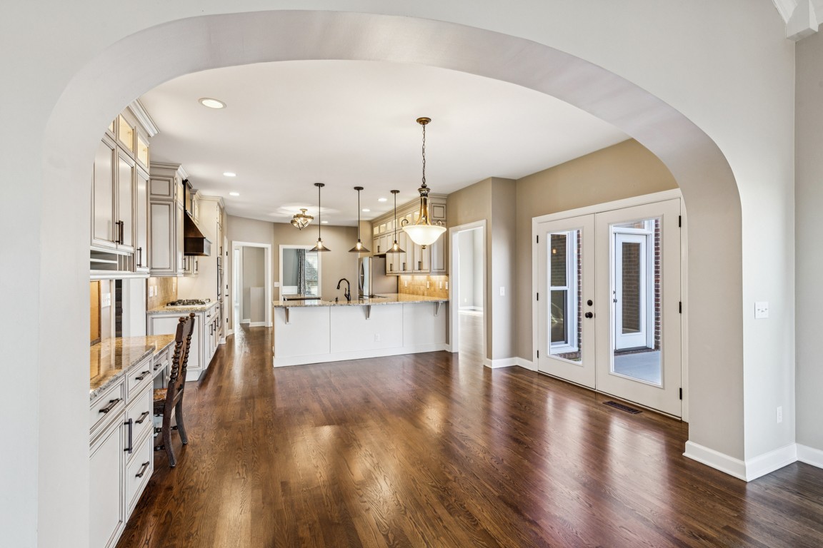 230 Temple Crest Trail Franklin, TN 37069 - Photo 8 of 40 a view of a living room and a dining room with wooden floor
