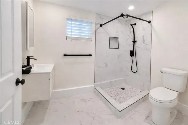 a bathroom with a shower a toilet and a shower