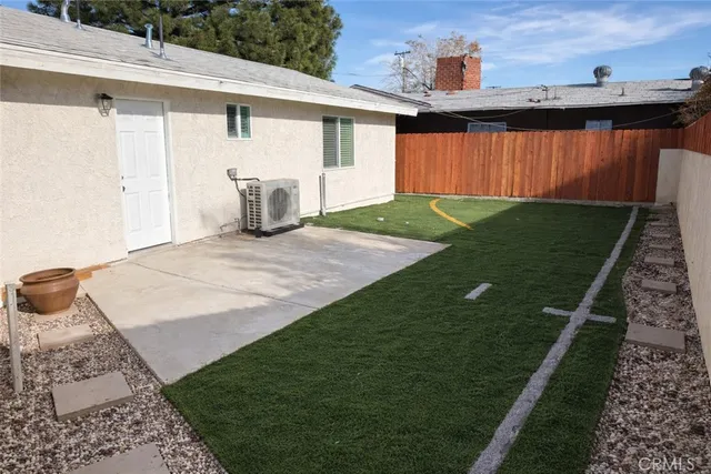 a view of a backyard with wooden fence