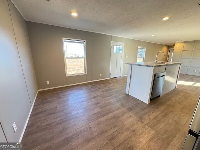 a view of kitchen with furniture and wooden floor