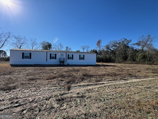 805 Smart Road Alma, GA 31510 - Photo 34 of 41 a view of a house with a yard