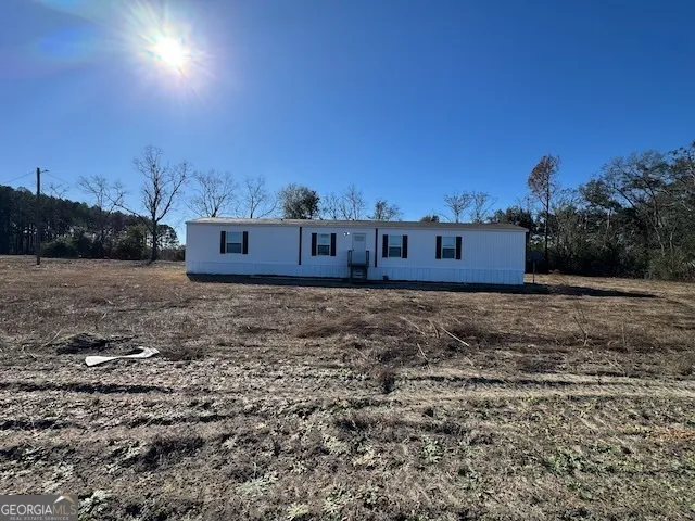 a view of a yard with wooden fence