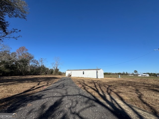 805 Smart Road Alma, GA 31510 - Photo 37 of 41 a view of a dry yard with wooden fence