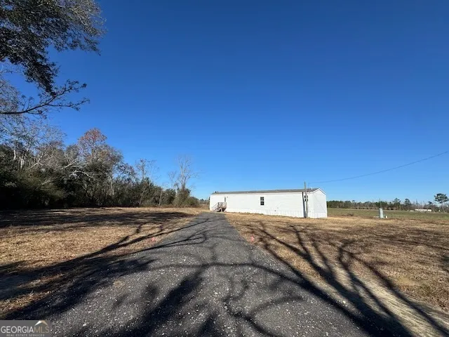 a view of a road with an ocean beach