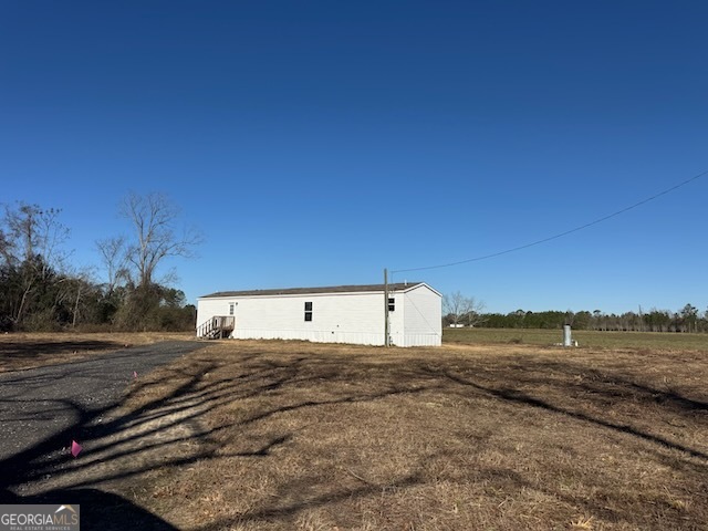 805 Smart Road Alma, GA 31510 - Photo 41 of 41 a view of a dry yard with wooden fence