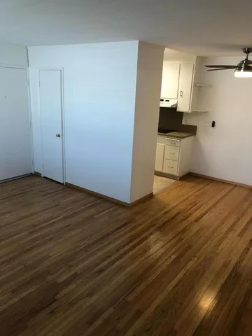 a view of a kitchen with wooden floor