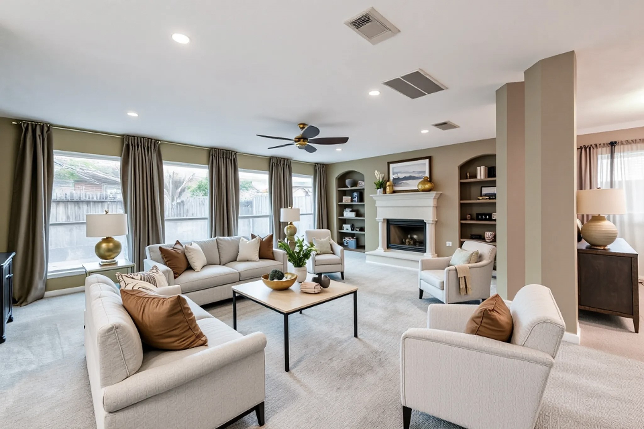 a living room with furniture fireplace and a large window