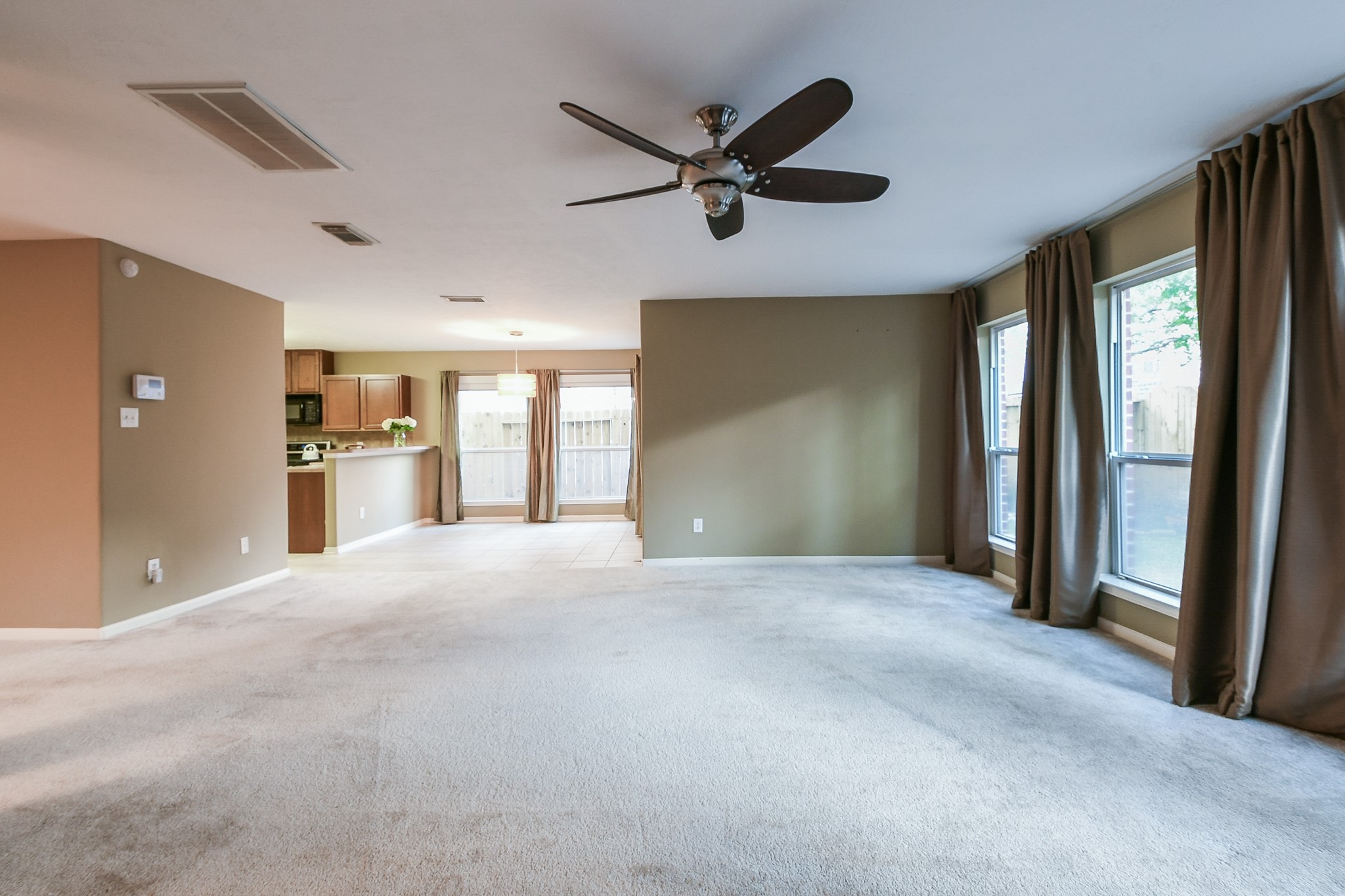 2415 Lacyberry Street Houston, TX 77080 - Photo 11 of 36 a view of an empty room with a window and a kitchen