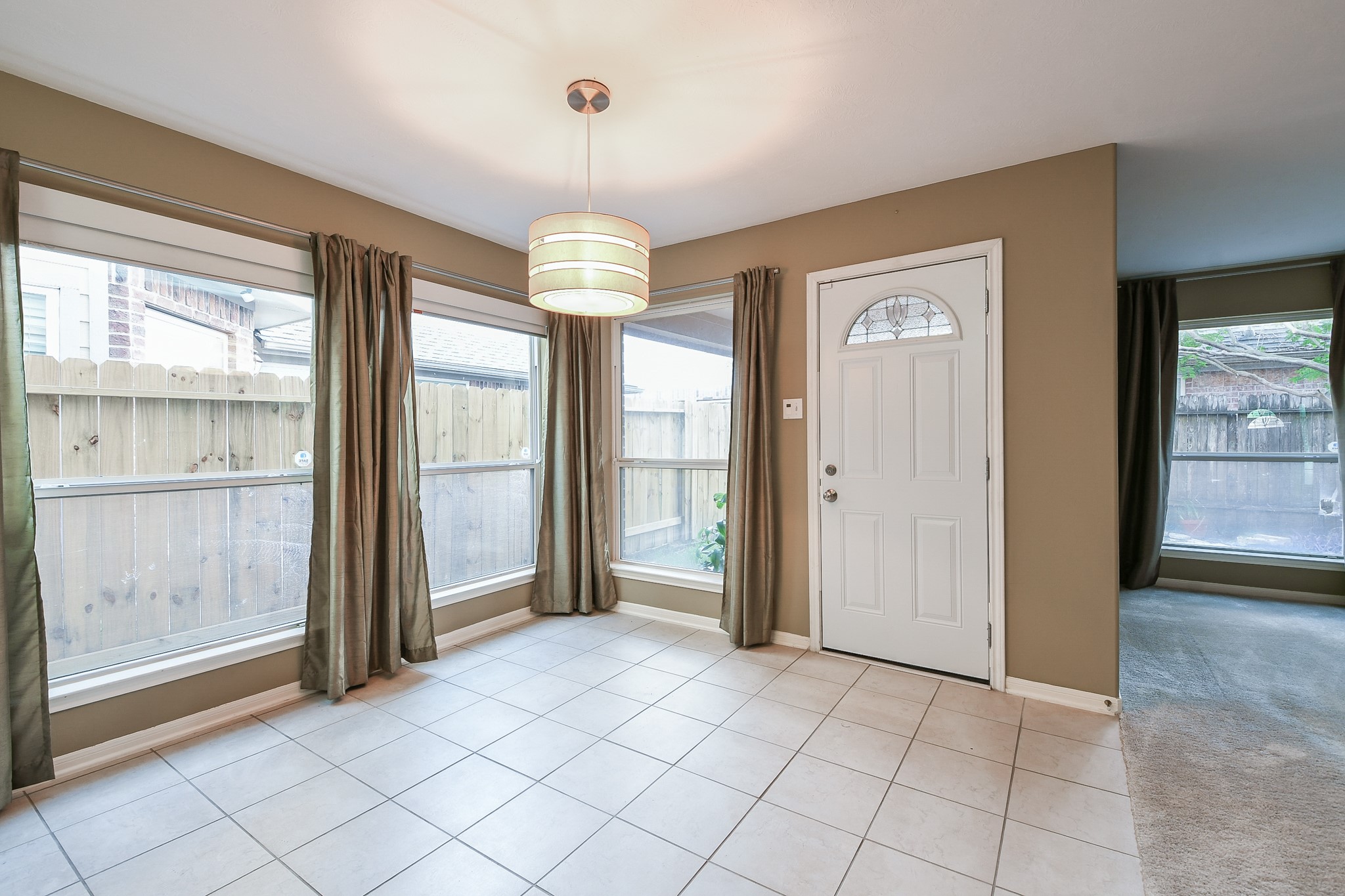 2415 Lacyberry Street Houston, TX 77080 - Photo 14 of 36 a view of a livingroom with a chandelier fan and windows