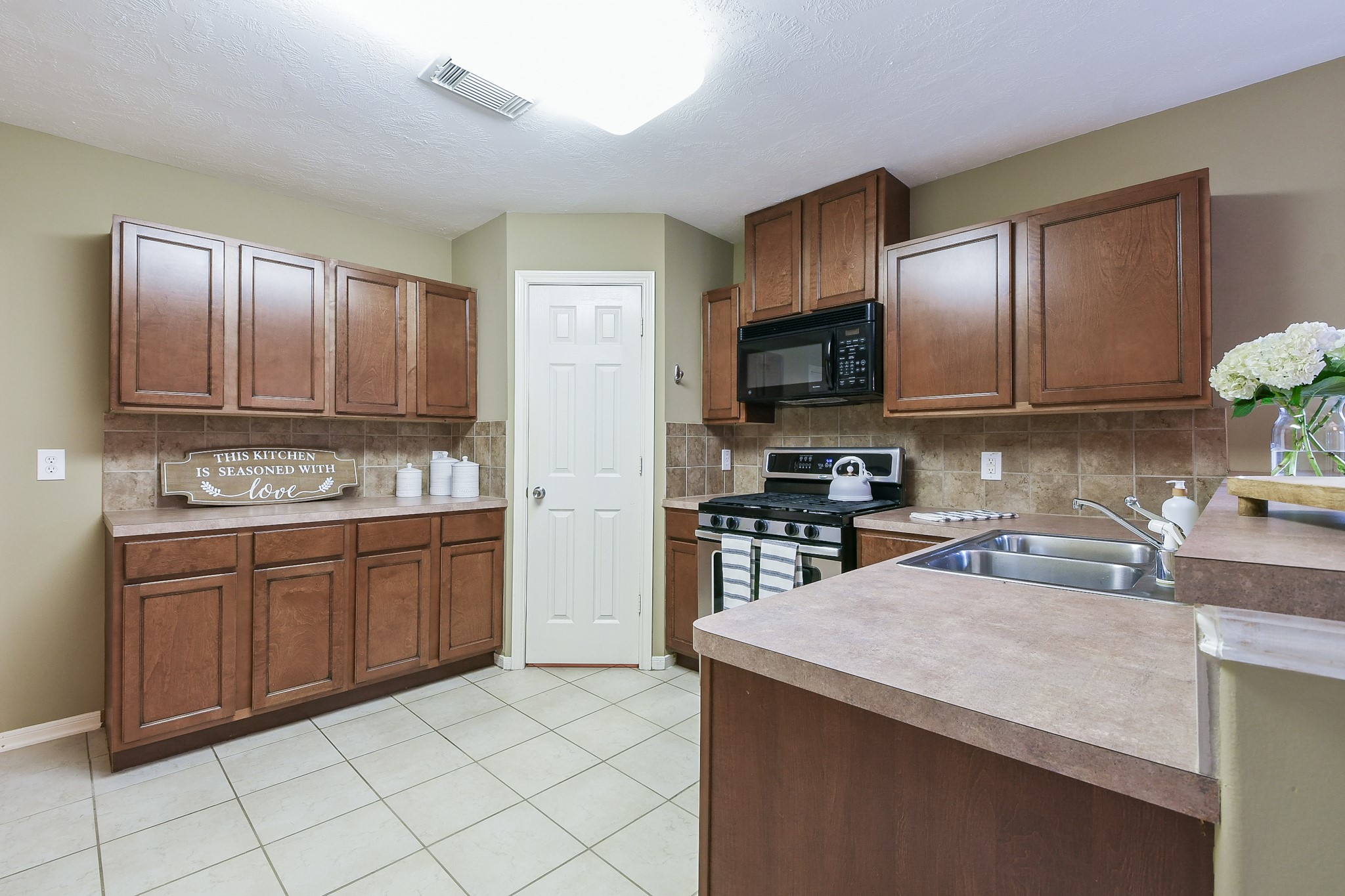 2415 Lacyberry Street Houston, TX 77080 - Photo 15 of 36 a kitchen with granite countertop a sink stainless steel appliances and cabinets