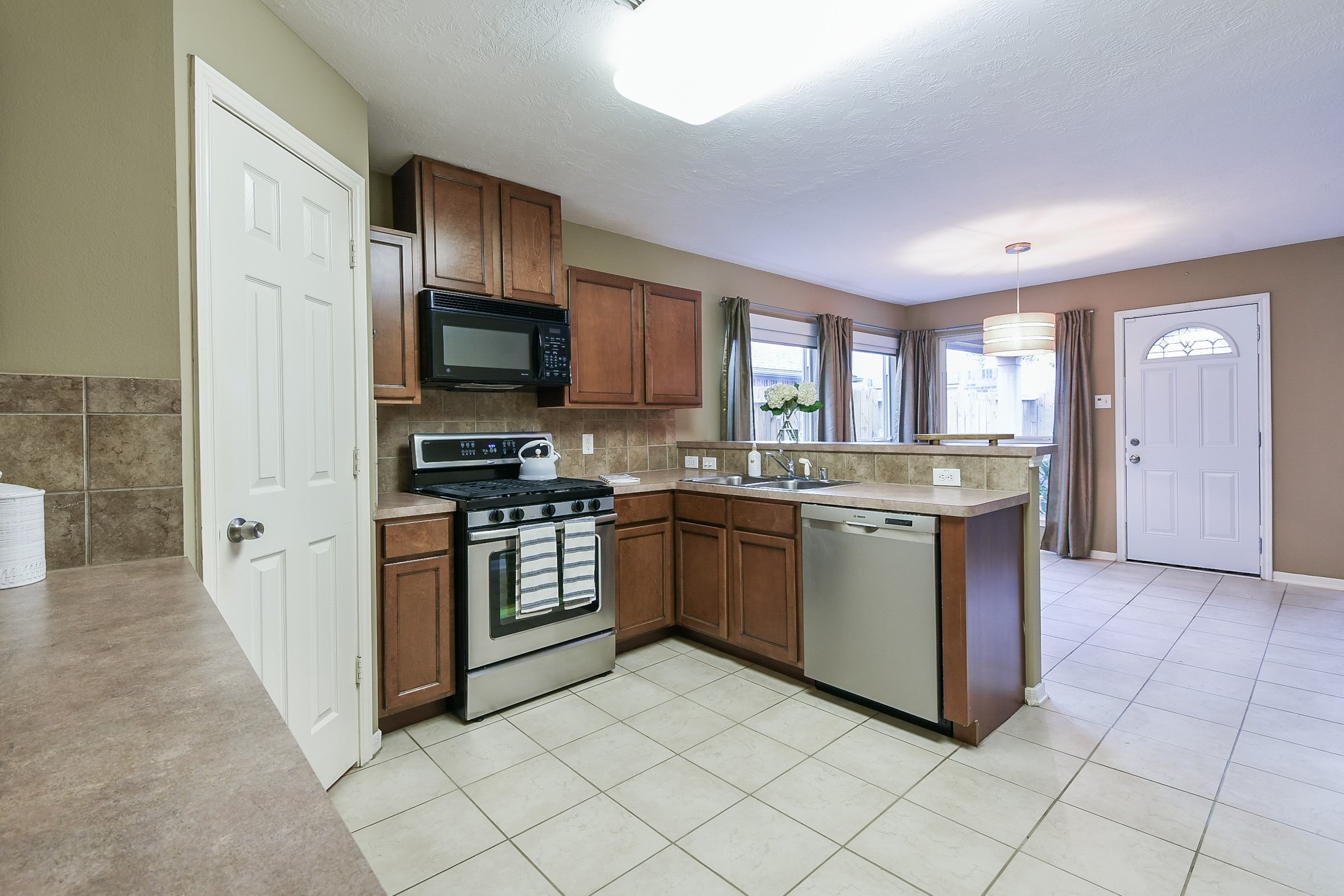 2415 Lacyberry Street Houston, TX 77080 - Photo 16 of 36 a kitchen with a sink cabinets and stainless steel appliances
