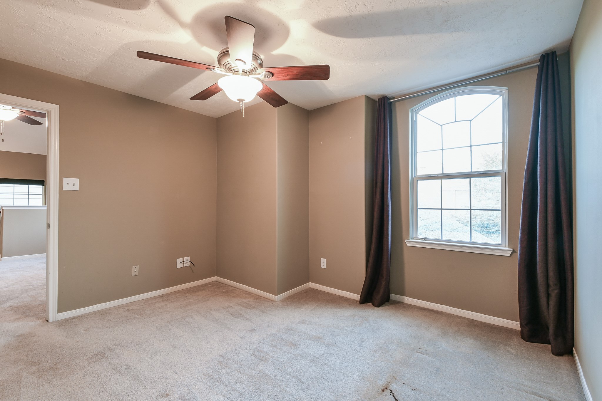 2415 Lacyberry Street Houston, TX 77080 - Photo 29 of 36 an empty room with windows and fan