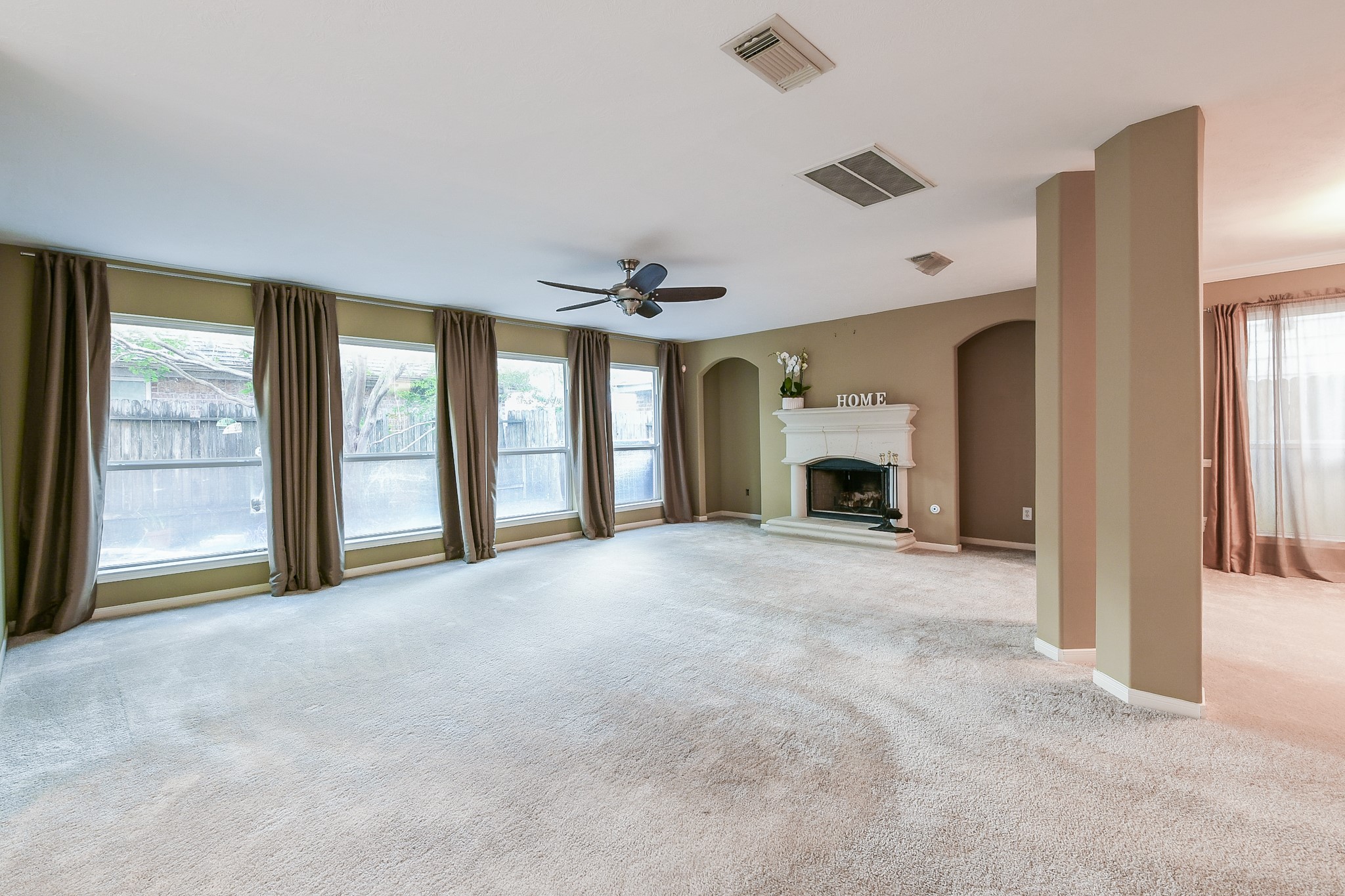 2415 Lacyberry Street Houston, TX 77080 - Photo 9 of 36 a view of an empty room with a fireplace and a window