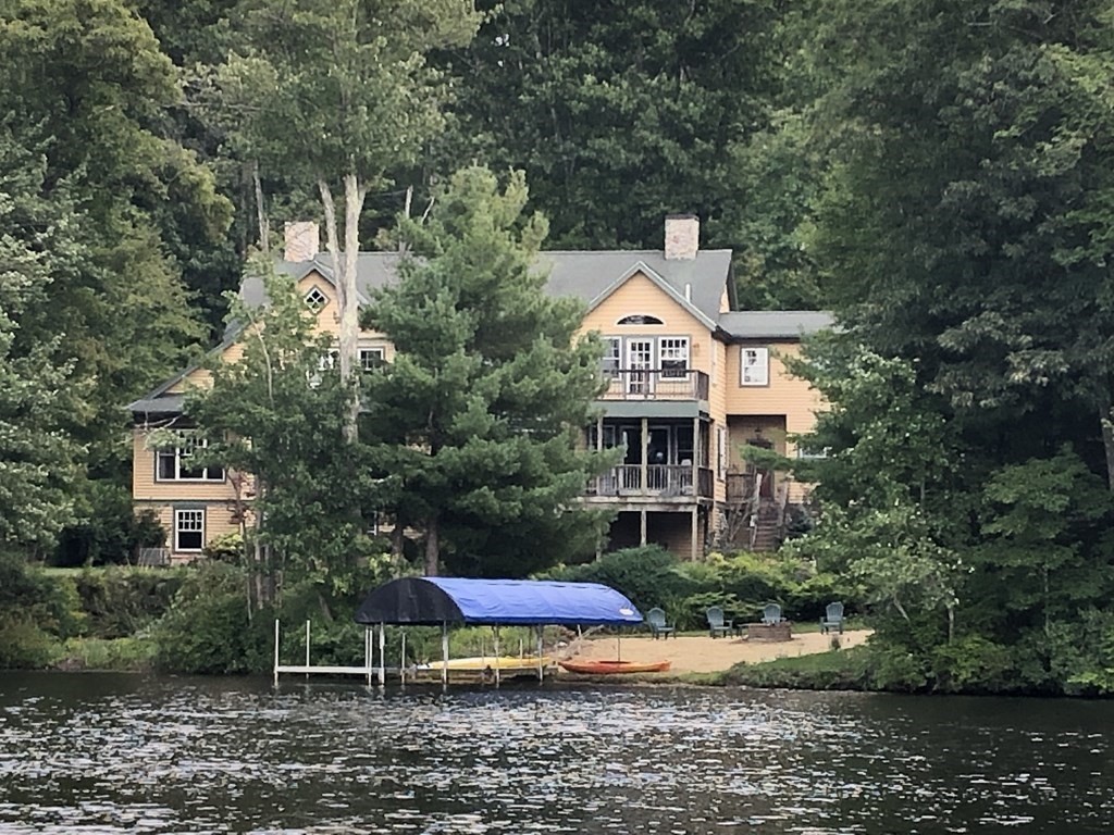 a aerial view of a house with a yard and sitting area