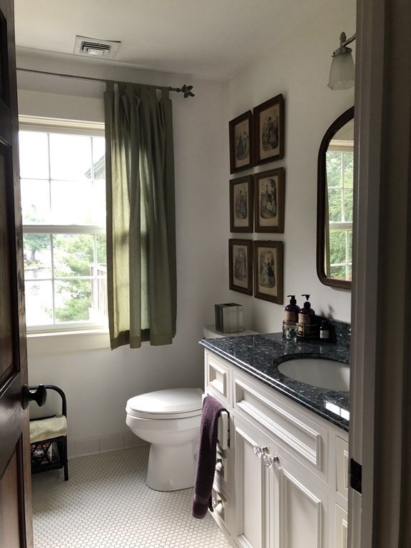 12 Estabrook Park Road Westminster, MA 01473 - Photo 14 of 29 a bathroom with a double vanity sink a toilet and a window