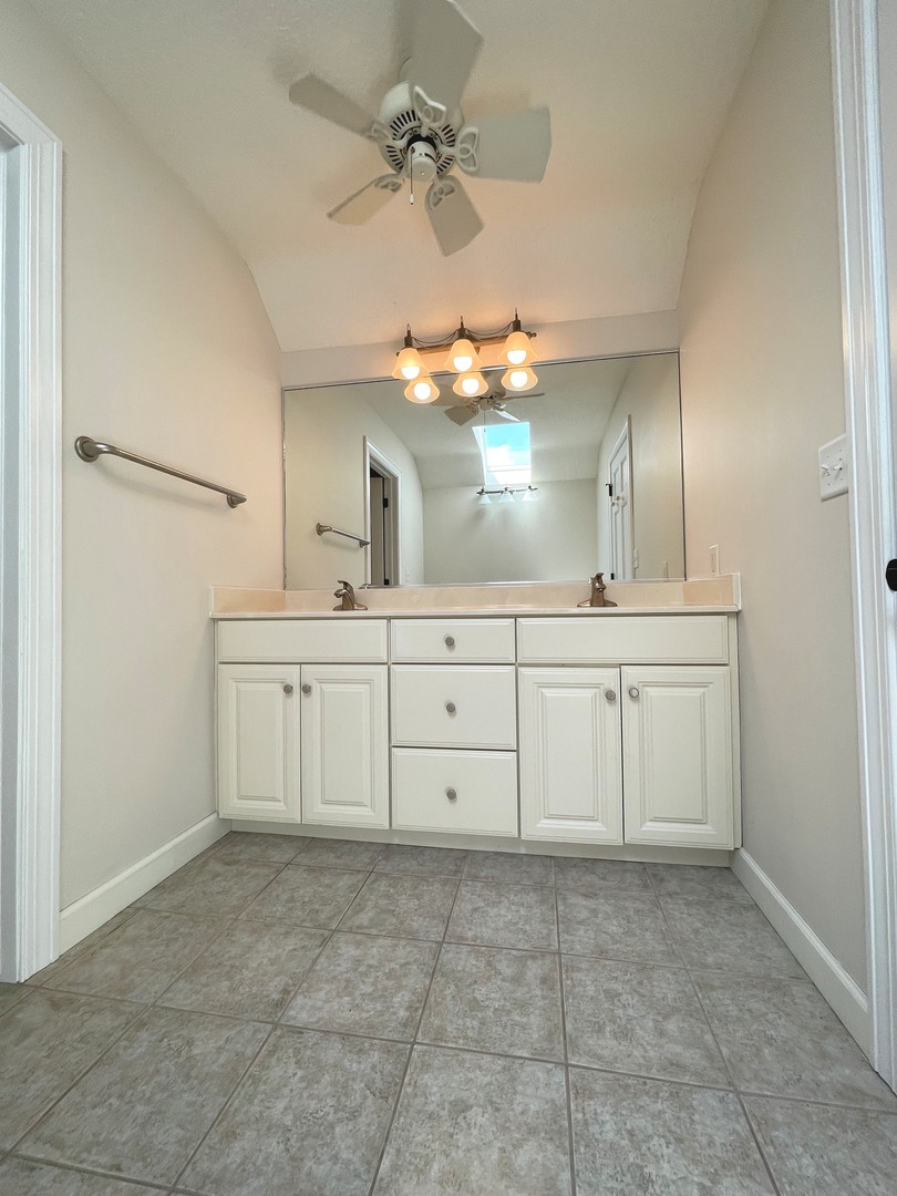 2239 Riverview Road Rock Falls, IL 61071 - Photo 43 of 70 a bathroom with a sink a large mirror and a vanity