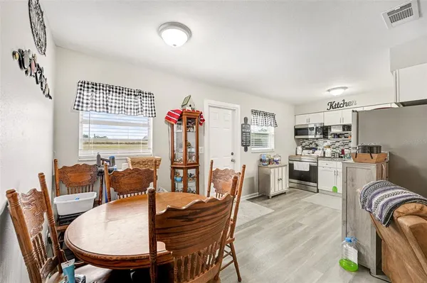 a dining room with furniture a window and kitchen view