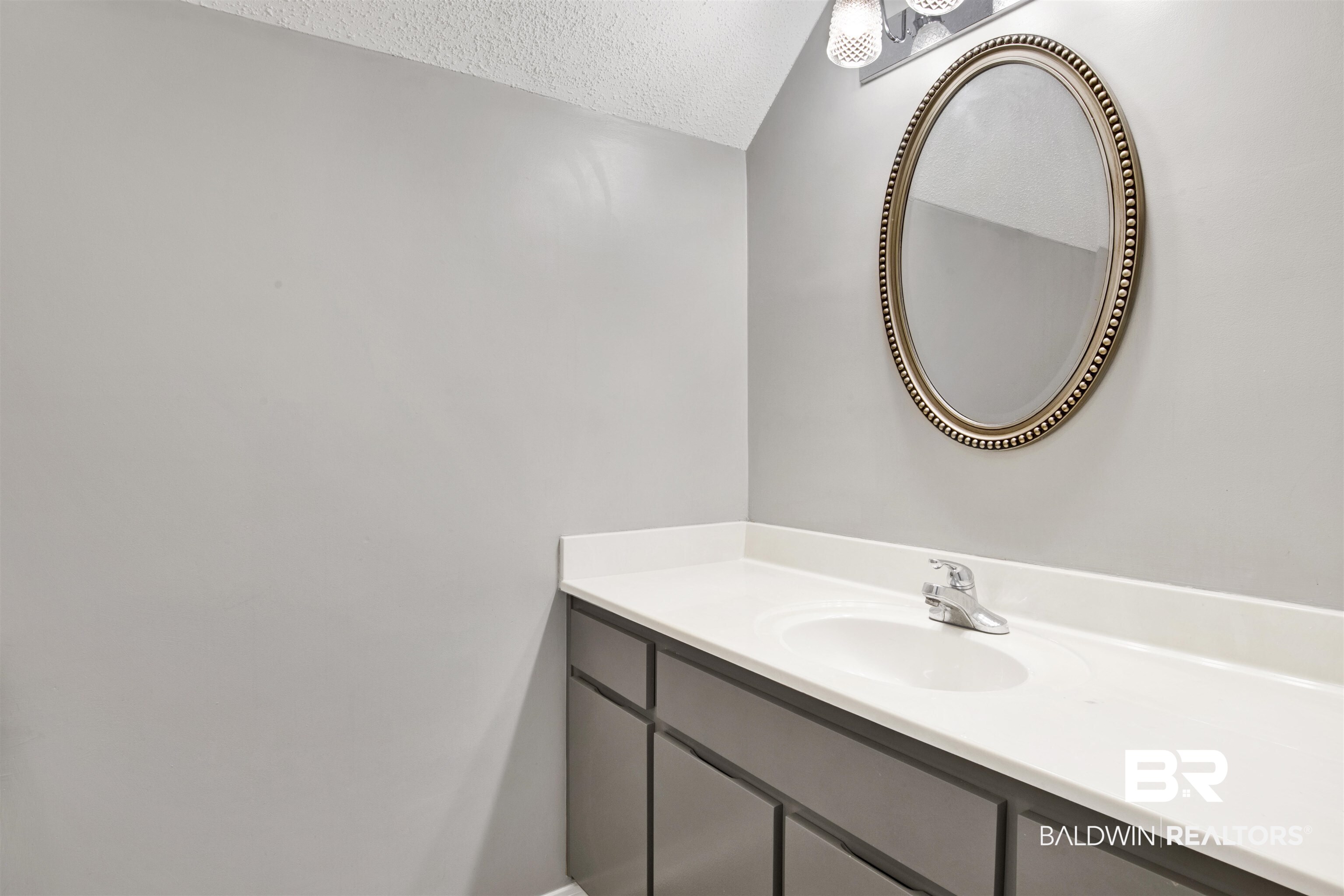 25700 Austin Road Daphne, AL 36526 - Photo 20 of 36 Bathroom featuring a textured ceiling and vanity