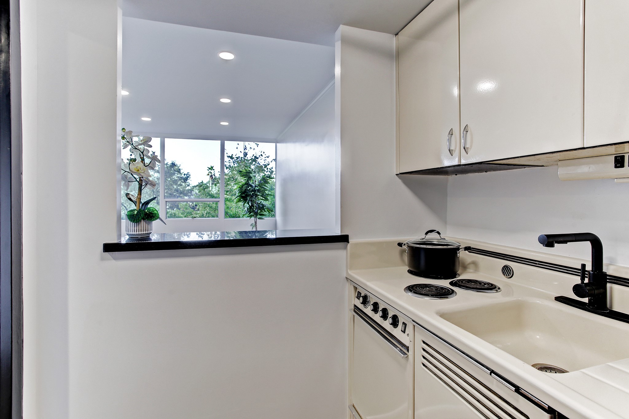 2701 Westheimer Road, Unit 2J Houston, TX 77098 - Photo 5 of 10 a kitchen with stainless steel appliances granite countertop a sink and a stove