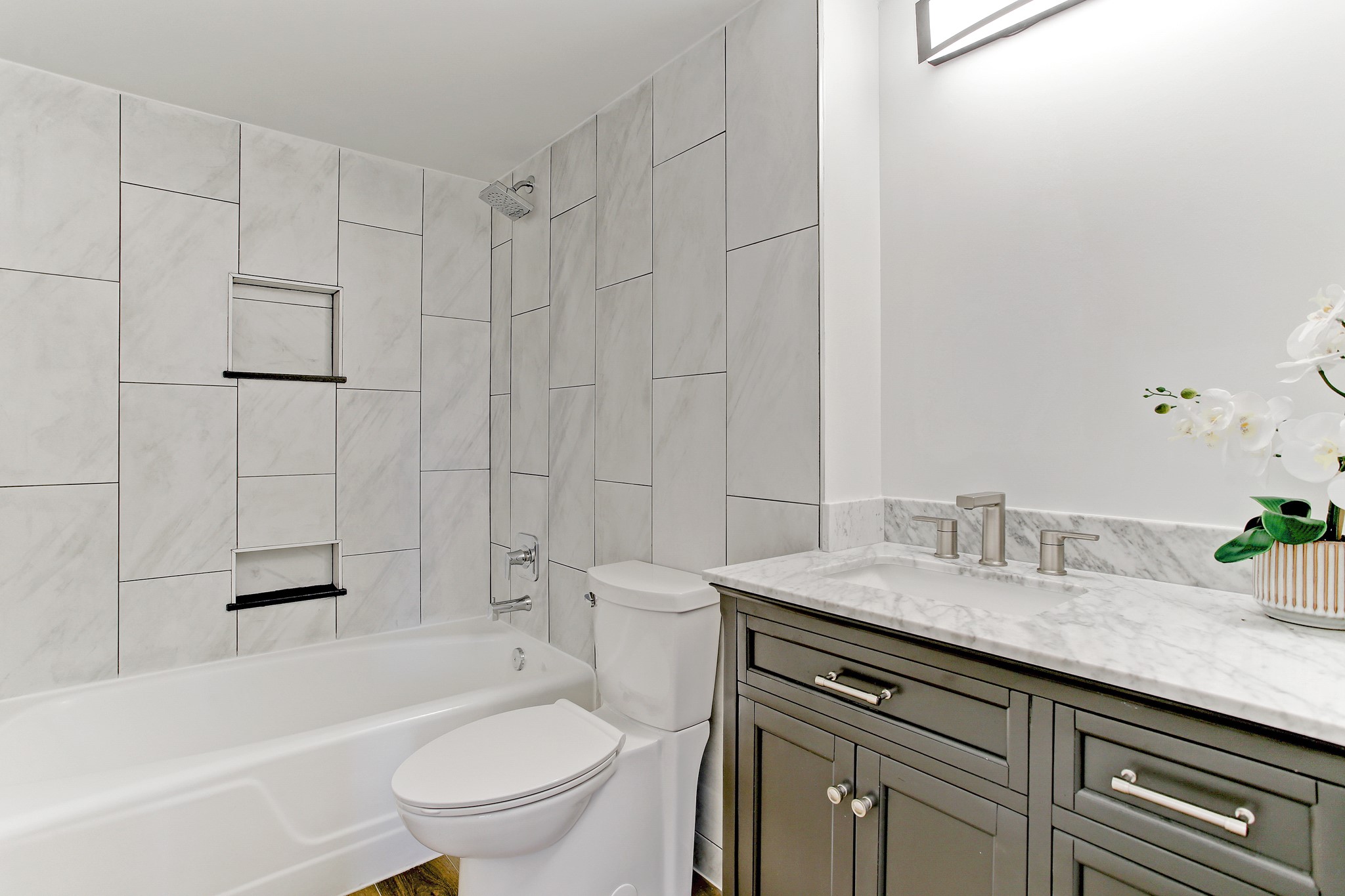 2701 Westheimer Road, Unit 2J Houston, TX 77098 - Photo 10 of 10 a bathroom with a granite countertop sink toilet and shower