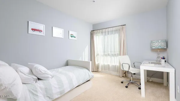 a bedroom with a bed and a table