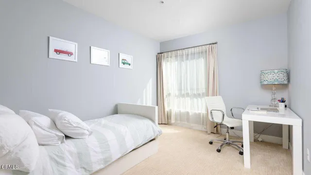 a bedroom with a bed and a table