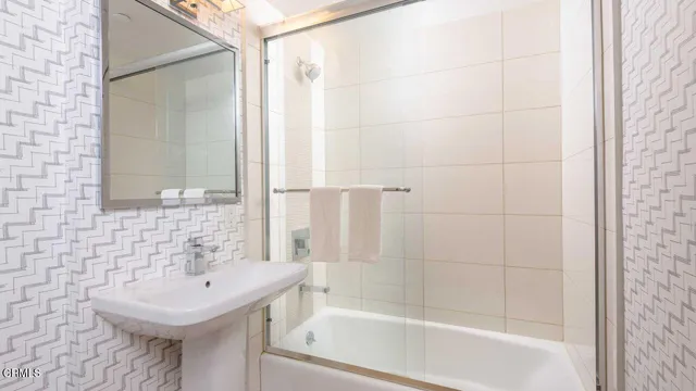 a bathroom with a sink a mirror and a bathtub