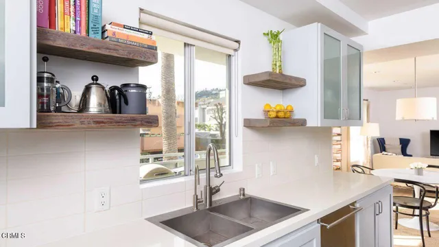 a kitchen with a sink a counter and cabinets
