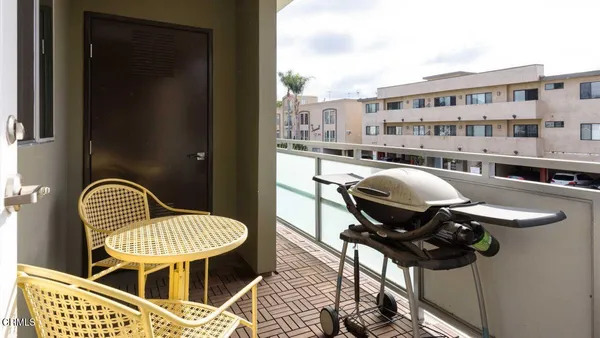 a balcony with table and chairs