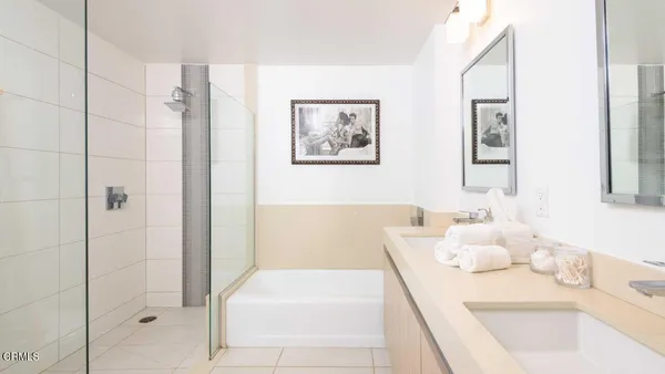 a bathroom with a tub sink and mirror