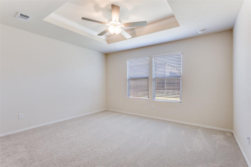 843 Ozark Path Princeton, TX 75407 - Photo 8 of 13 an empty room with a window and a fan