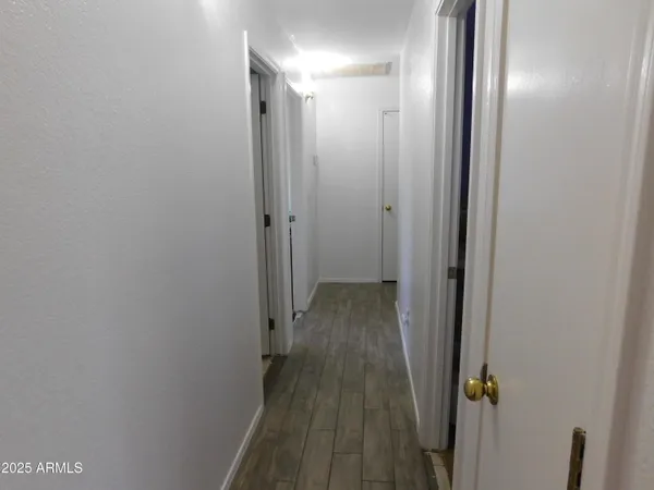 a bedroom with a bed window and wooden floor
