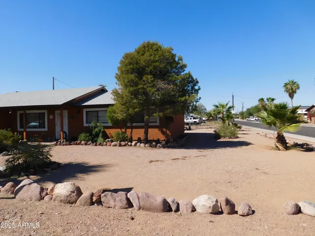a view of a chairs and table in backyard