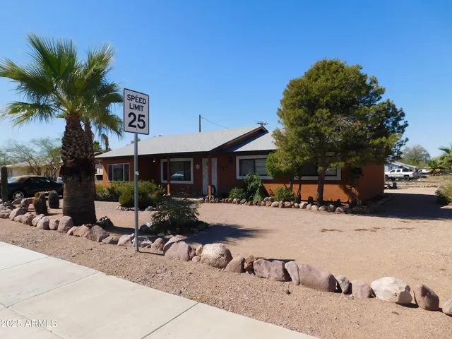 a kitchen with stainless steel appliances granite countertop a refrigerator sink and stove
