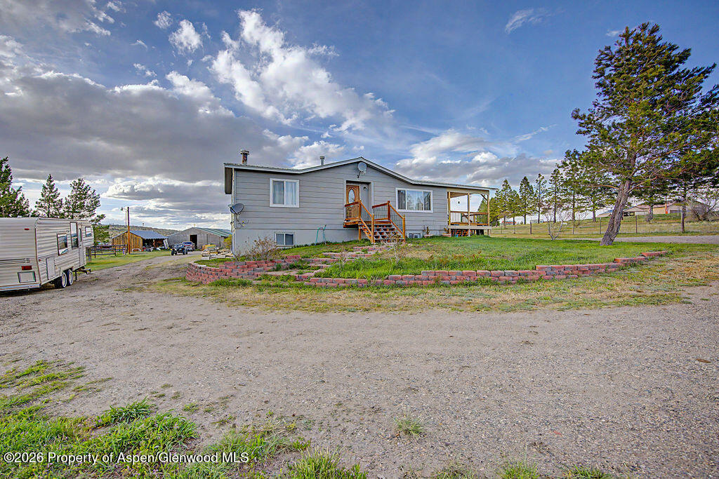 723 Barbara Drive Craig, CO 81625 - Photo 1 of 48 a view of a house with a big yard and large trees