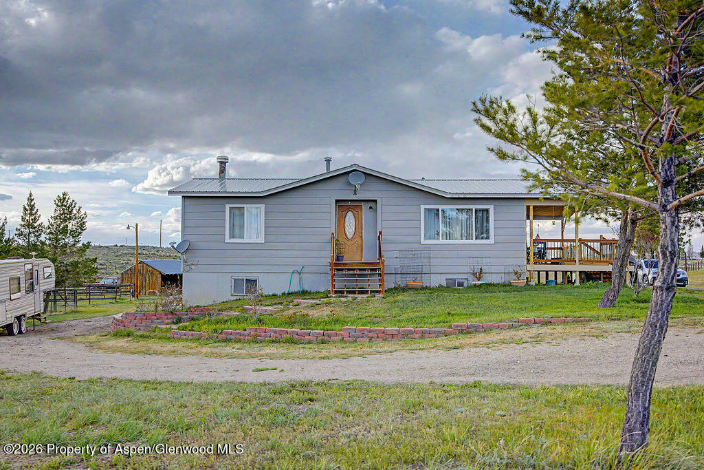 723 Barbara Drive Craig, CO 81625 - Photo 2 of 48 a front view of a house with a garden and tree
