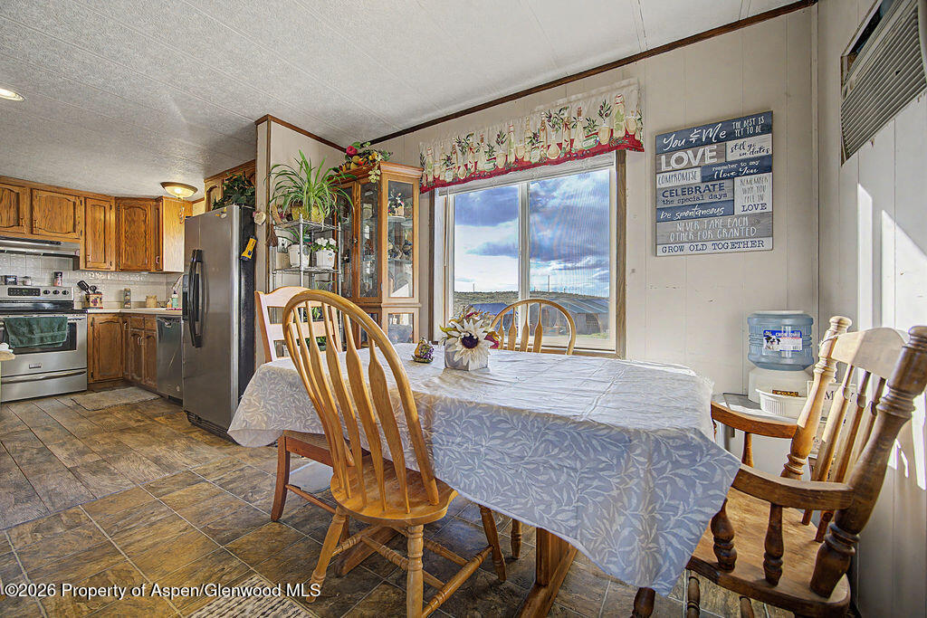 723 Barbara Drive Craig, CO 81625 - Photo 32 of 48 a view of a dining room with furniture a chandelier and wooden floor